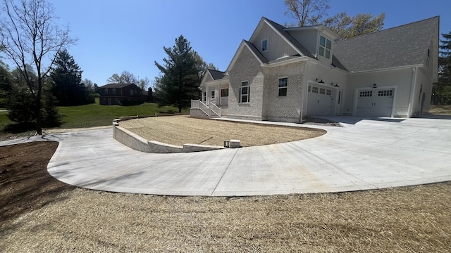 1168 N Franklin Ave, Cookeville, TN 38501 - view of side of home with concrete driveway, a garage, a shingled roof, and brick siding