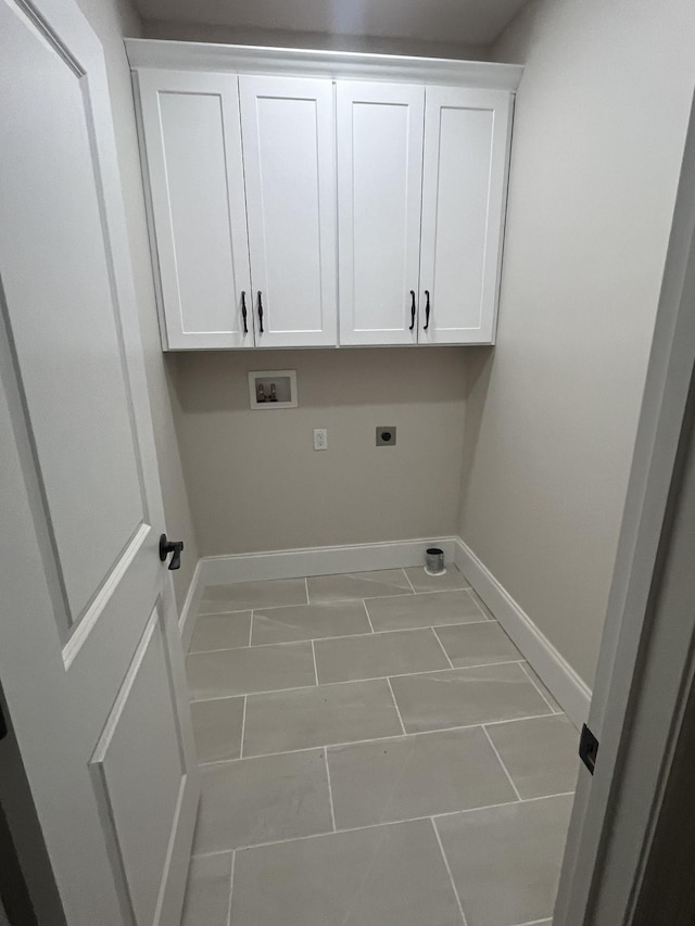 1168 N Franklin Ave, Cookeville, TN 38501 - laundry area featuring electric dryer hookup, marble look tiles, baseboards, hookup for a washing machine, and cabinet space