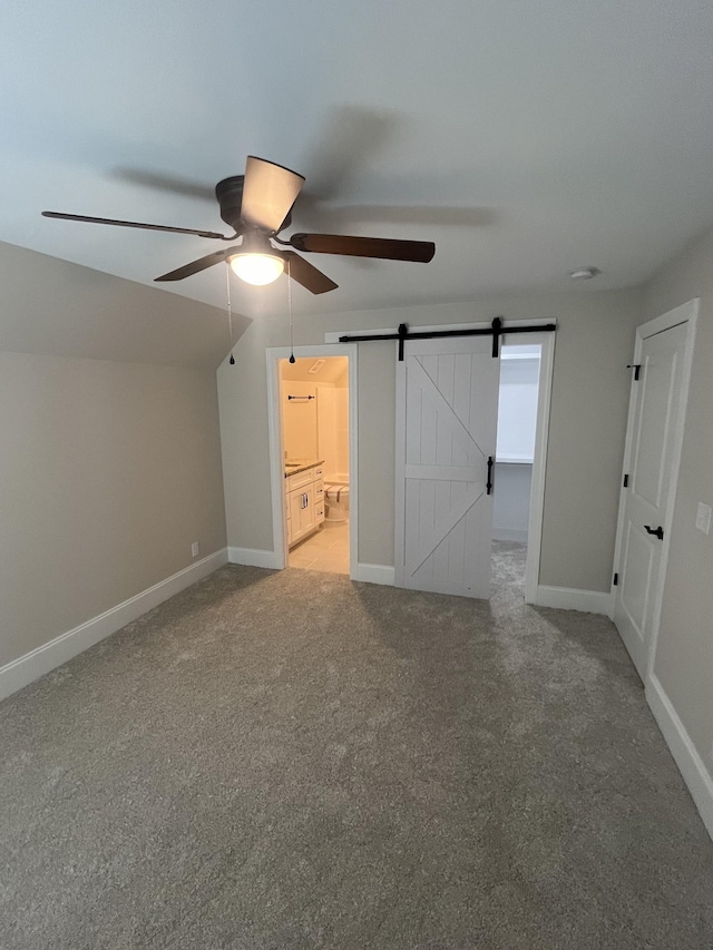 1168 N Franklin Ave, Cookeville, TN 38501 - unfurnished bedroom featuring carpet flooring, a barn door, connected bathroom, and baseboards