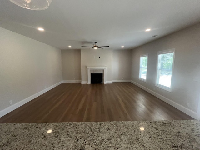 1168 N Franklin Ave, Cookeville, TN 38501 - unfurnished living room featuring ceiling fan, dark wood-style flooring, a fireplace, baseboards, and recessed lighting