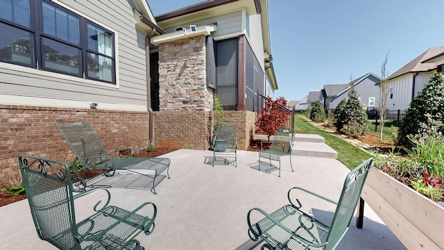 view of patio with a residential view and fence