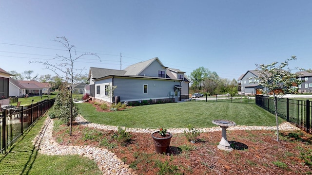 view of yard featuring a fenced backyard and a residential view
