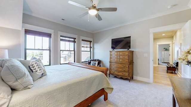 bedroom with ceiling fan, light colored carpet, baseboards, and ornamental molding