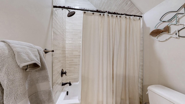 full bathroom with shower / bath combo with shower curtain and toilet