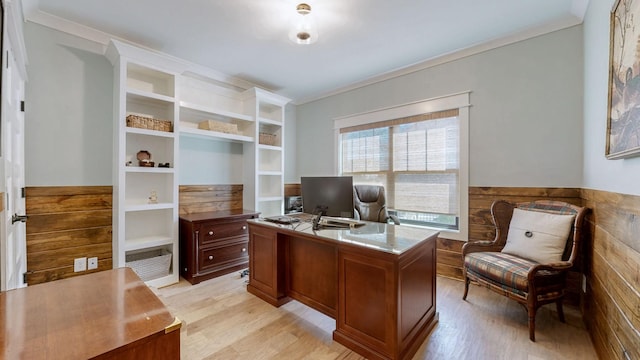 office with crown molding, a wainscoted wall, and light wood-style floors