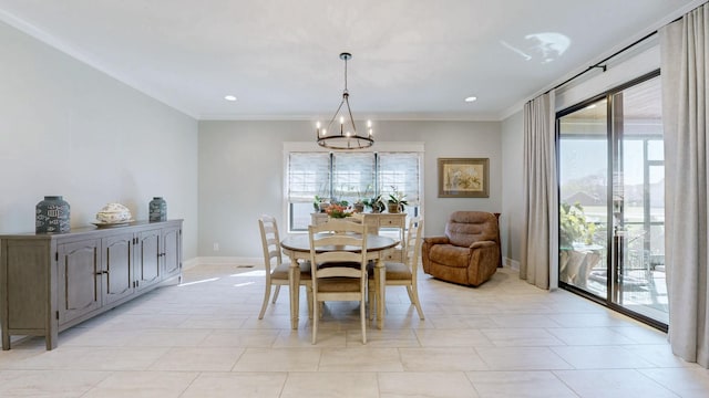 dining room with a chandelier, crown molding, baseboards, and a wealth of natural light