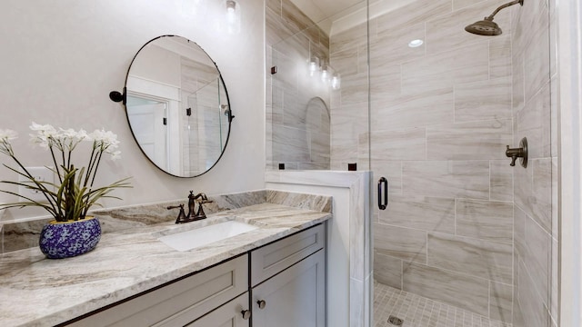 full bathroom with a shower stall and vanity