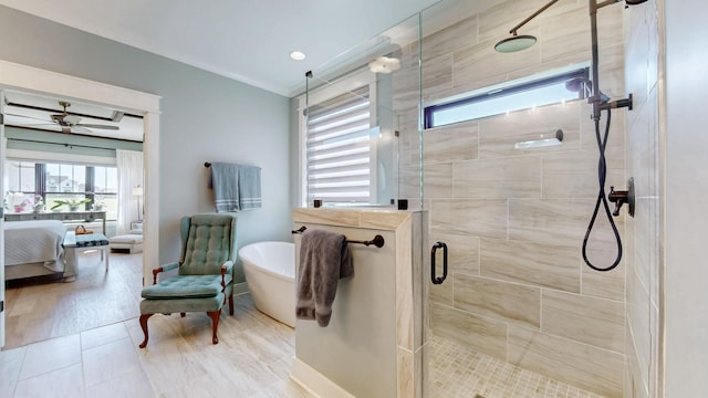 ensuite bathroom featuring baseboards, tile patterned flooring, ensuite bath, a shower stall, and a freestanding bath