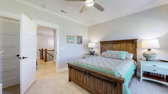bedroom with visible vents, baseboards, ornamental molding, a ceiling fan, and light carpet