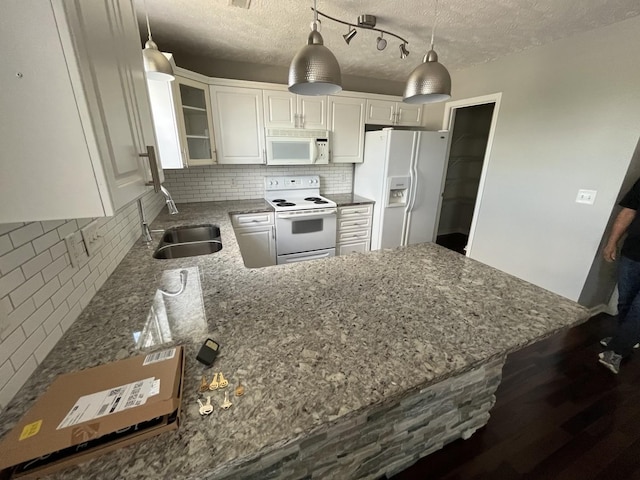 3001 Hamilton Church Rd Unit 216, Antioch, TN 37013 - kitchen with dark stone countertops, white cabinets, a sink, white appliances, and backsplash