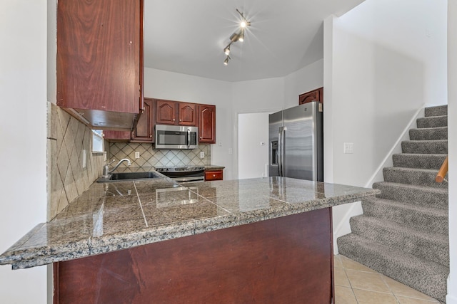 142 Big Ben Ct, Franklin, TN 37067 - kitchen with tile countertops, a peninsula, a sink, stainless steel appliances, and backsplash