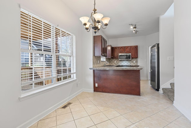 142 Big Ben Ct, Franklin, TN 37067 - kitchen featuring an inviting chandelier, light tile patterned floors, visible vents, appliances with stainless steel finishes, and backsplash