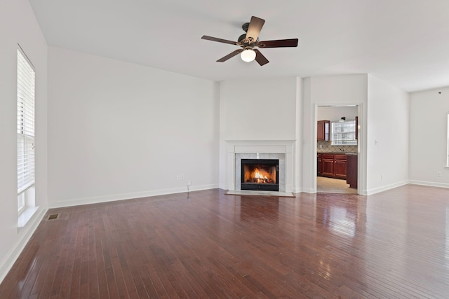 142 Big Ben Ct, Franklin, TN 37067 - unfurnished living room featuring visible vents, a ceiling fan, a high end fireplace, and dark wood-style floors