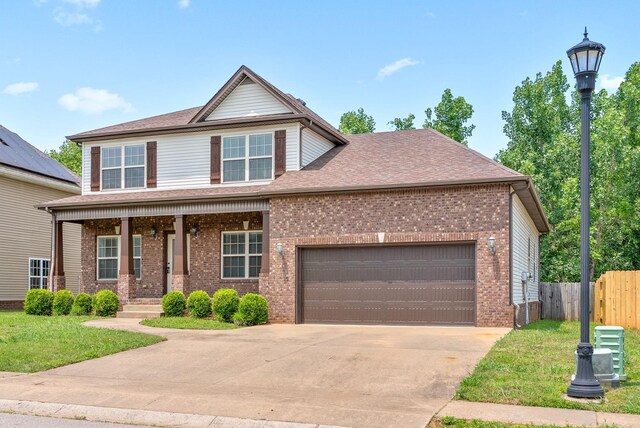 1313 Allmon Dr, Clarksville, TN 37042 - view of front facade featuring covered porch, driveway, a garage, brick siding, and roof with shingles