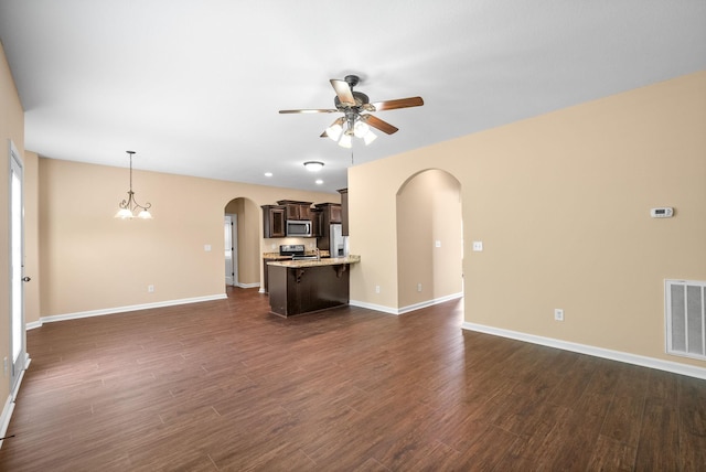 1313 Allmon Dr, Clarksville, TN 37042 - unfurnished living room with arched walkways, ceiling fan, dark wood-style flooring, and baseboards
