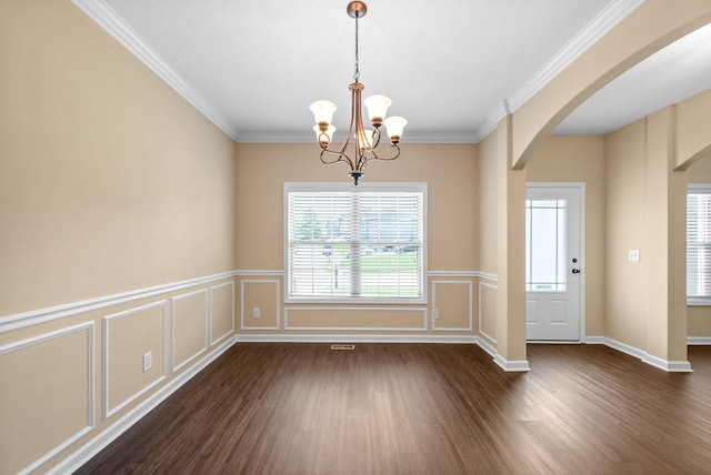 1313 Allmon Dr, Clarksville, TN 37042 - unfurnished dining area with arched walkways, dark wood finished floors, a chandelier, a decorative wall, and crown molding