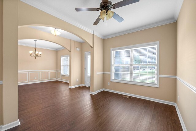 1313 Allmon Dr, Clarksville, TN 37042 - empty room with dark wood-style floors, arched walkways, ornamental molding, ceiling fan, and a chandelier