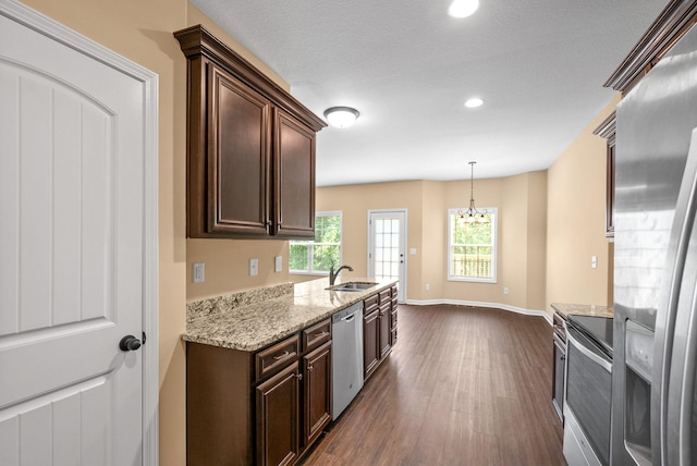 1313 Allmon Dr, Clarksville, TN 37042 - kitchen with appliances with stainless steel finishes, a sink, dark wood-style flooring, dark brown cabinets, and recessed lighting