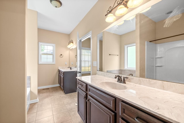 1313 Allmon Dr, Clarksville, TN 37042 - full bath featuring two vanities, a garden tub, tile patterned floors, baseboards, and a shower