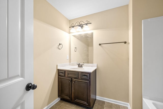 1313 Allmon Dr, Clarksville, TN 37042 - bathroom with vanity, a bath, baseboards, and tile patterned floors