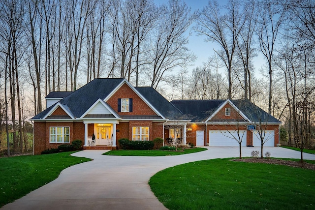175 Southern Woods Ct, Cookeville, TN 38506 - view of front of house with brick siding, curved driveway, an attached garage, and a front lawn
