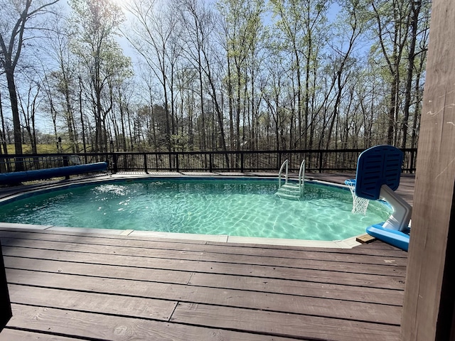 view of pool featuring a wooden deck and a fenced in pool