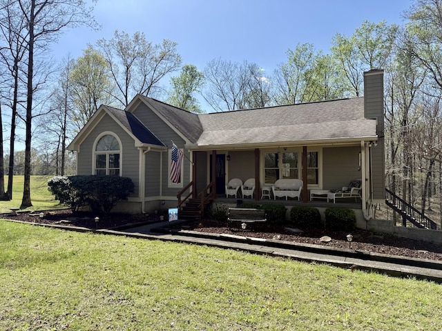ranch-style house featuring a porch, roof with shingles, a chimney, and a front lawn