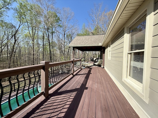 wooden terrace with a fenced in pool