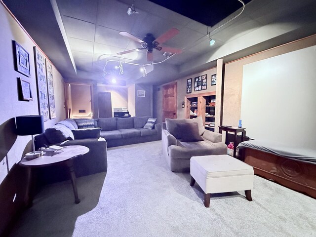 carpeted cinema featuring a ceiling fan