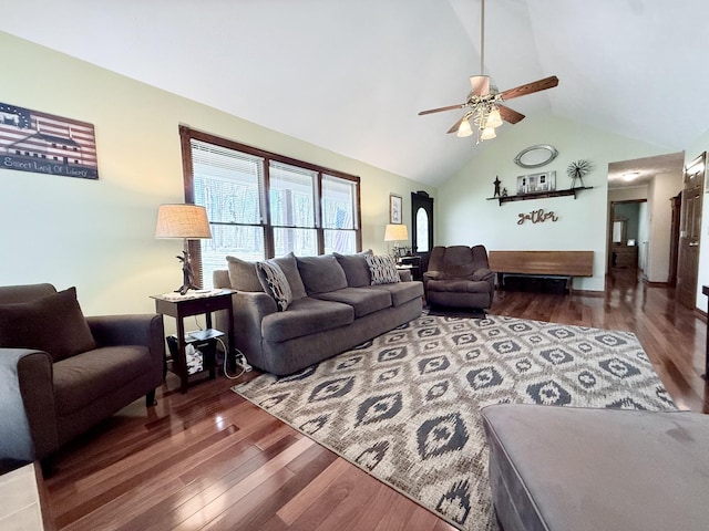 living area featuring high vaulted ceiling, a ceiling fan, and wood finished floors