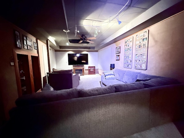 carpeted cinema featuring a raised ceiling