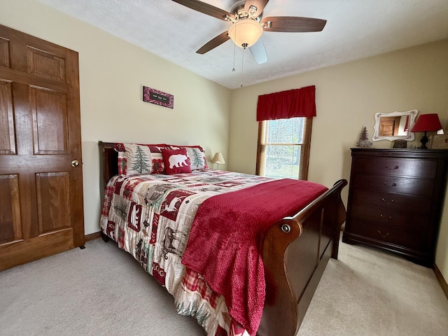 bedroom featuring light carpet, baseboards, and a ceiling fan