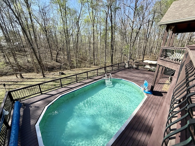 view of pool featuring a wooden deck and a fenced in pool