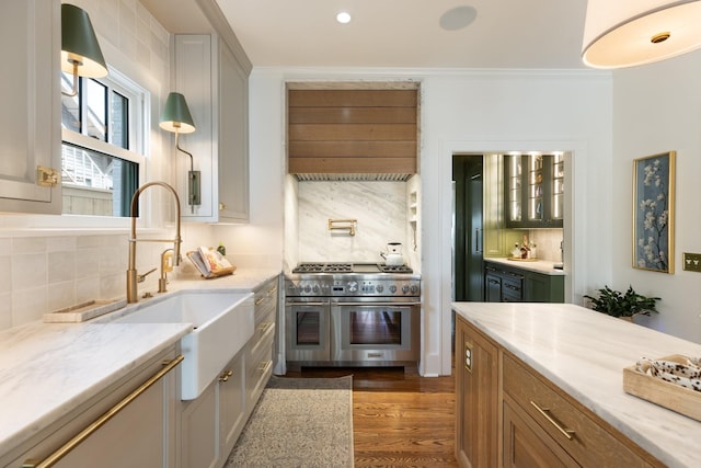 4610 Elkins Ave, Nashville, TN 37209 - kitchen with double oven range, a sink, tasteful backsplash, wood finished floors, and ornamental molding