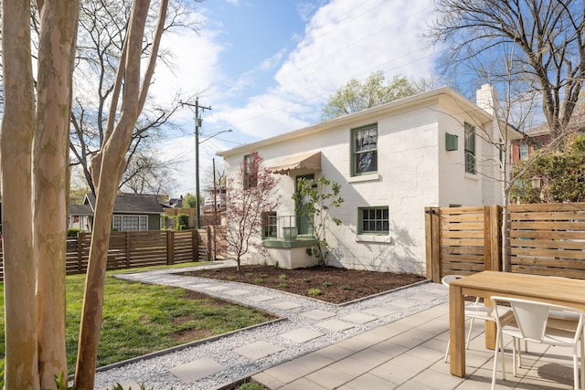 4610 Elkins Ave, Nashville, TN 37209 - view of front of home with concrete block siding, fence, and a chimney