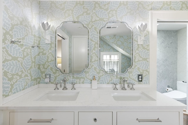 4610 Elkins Ave, Nashville, TN 37209 - bathroom featuring wallpapered walls, double vanity, and toilet