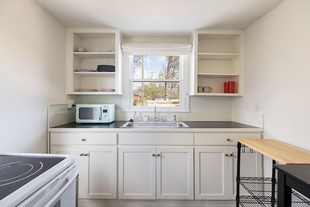 4610 Elkins Ave, Nashville, TN 37209 - kitchen featuring white appliances, open shelves, a sink, and white cabinets