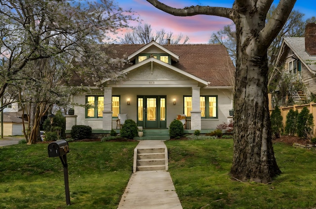 4610 Elkins Ave, Nashville, TN 37209 - view of front of home featuring a porch, a yard, and a shingled roof