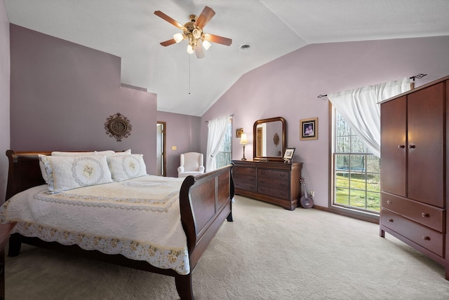 bedroom with ceiling fan, multiple windows, light carpet, and lofted ceiling