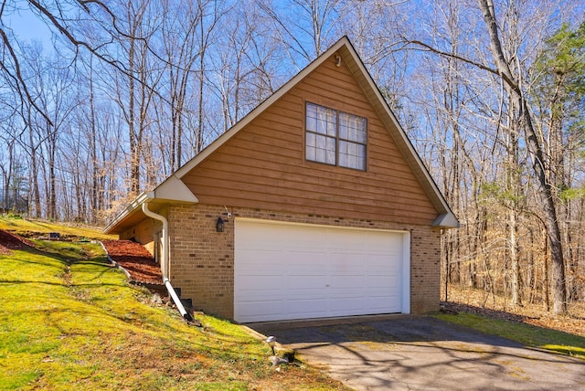 view of property exterior featuring aphalt driveway and brick siding