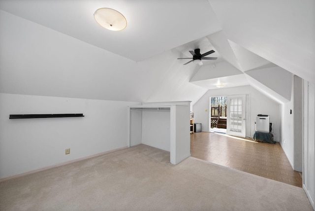 bonus room with a ceiling fan, light colored carpet, and vaulted ceiling