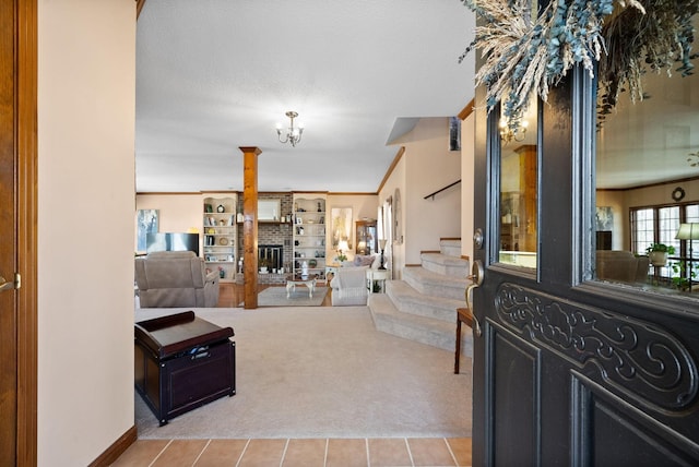 interior space with a chandelier, a fireplace, stairway, and ornamental molding