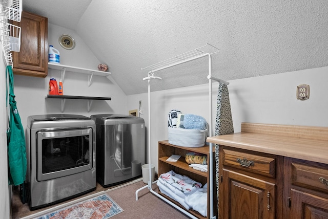 clothes washing area with a textured ceiling and separate washer and dryer