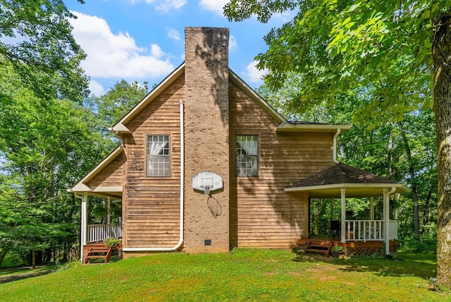 4862 Louise Rd, Cumberland Furnace, TN 37051 - view of home's exterior featuring a lawn and a chimney