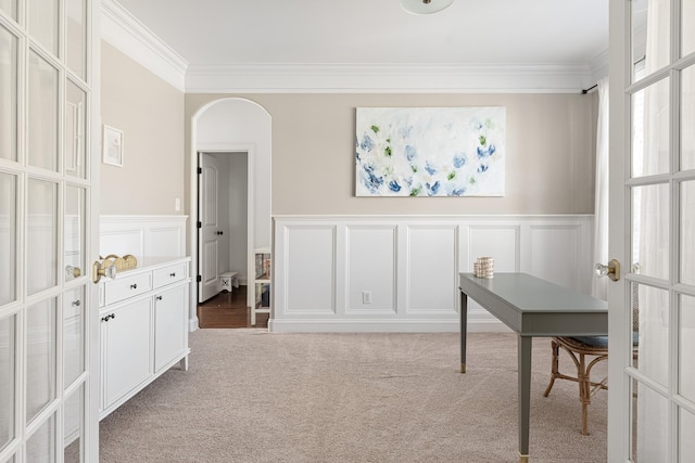 office area featuring a decorative wall, ornamental molding, carpet, and french doors