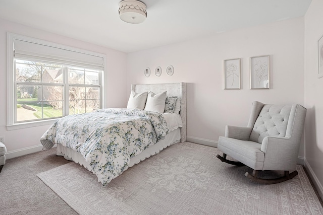 bedroom with light carpet and baseboards