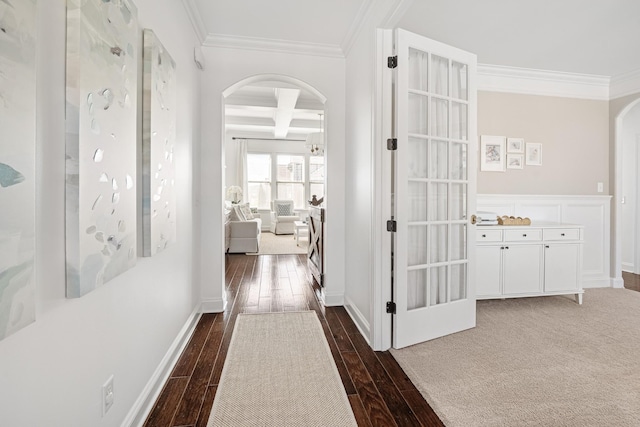 hall featuring arched walkways, crown molding, dark wood finished floors, and coffered ceiling