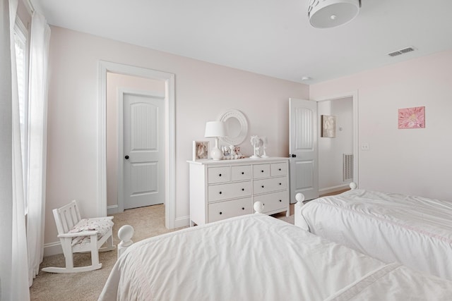 bedroom featuring visible vents, baseboards, and light colored carpet