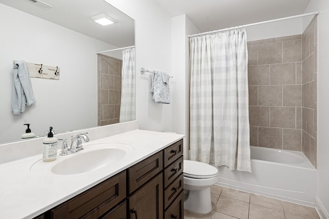 bathroom featuring visible vents, toilet, shower / bath combo with shower curtain, vanity, and tile patterned flooring