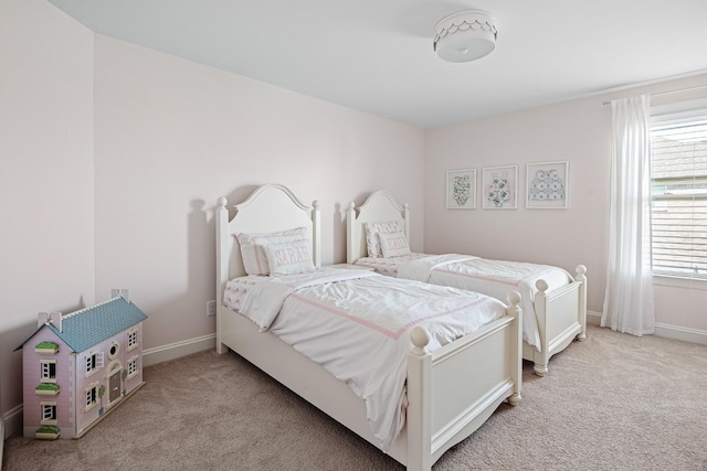 carpeted bedroom with baseboards
